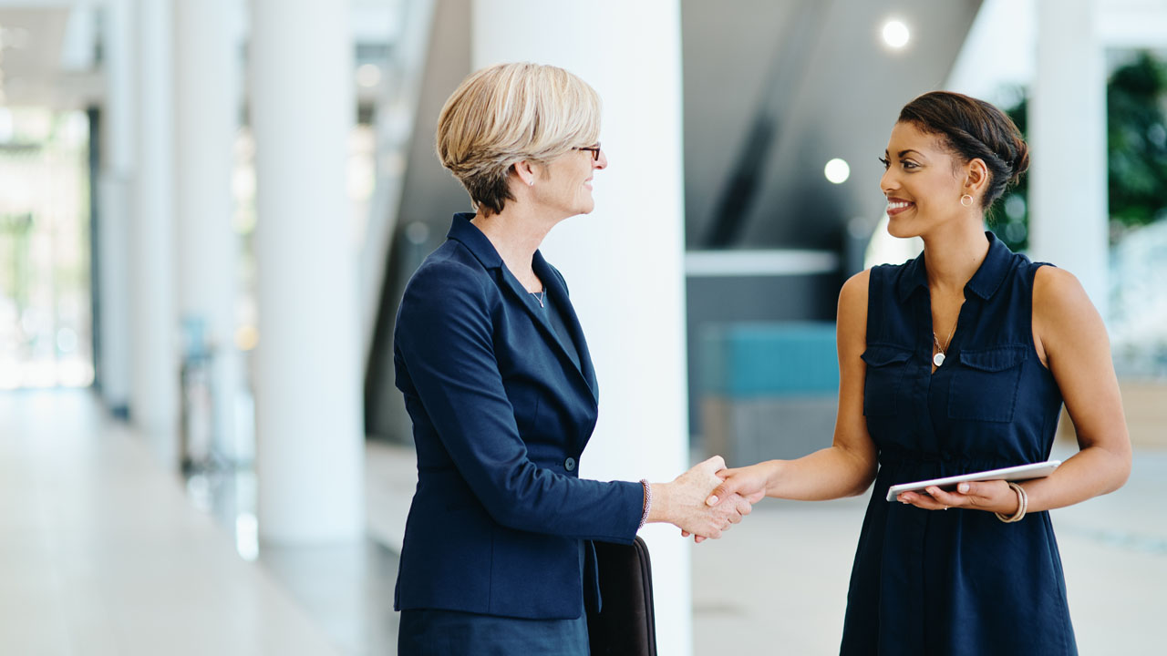 Two woman shaking hands